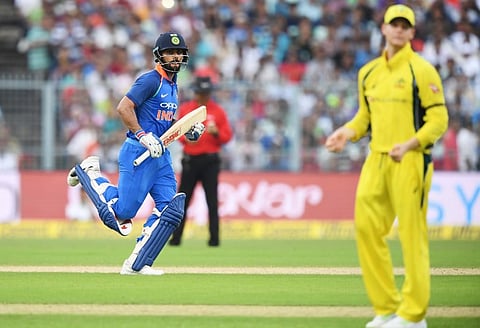 India's captain Virat Kohli (R) runs to complete a run as Australia's Steve Smith looks on. (Photo | AFP)