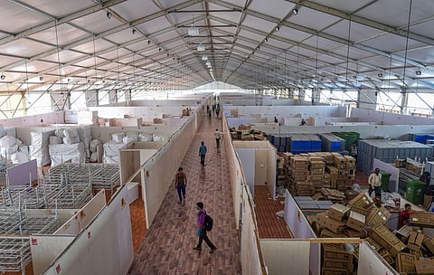 Workers carry out construction work at India's first open ground quarantine and isolation facility with 1 008 beds for semi-critical coronavirus patients at BKC in Mumbai Saturday May 16 2020. (Photo | PTI)