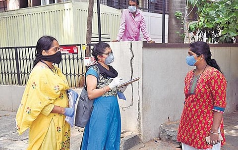 Government school teachers collect data on the Covid-19 outbreak from a resident at Malleswaram in Bengaluru on Friday | NAGARAJA GADEKAL