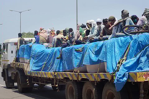 Migrants board a truck to travel to their native places during the ongoing nationwide COVID-19 lockdown in Bhubaneswar Friday May 15 2020. (Photo | PTI)