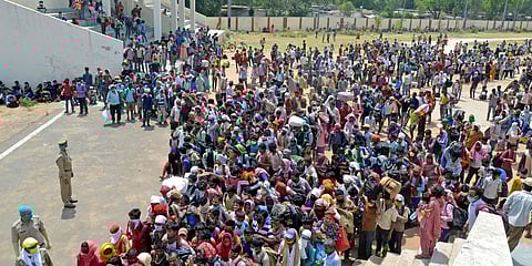 A large number of migrant workers gather at Govardhan Stadium in Agra on Monday. (Photo| ANI)