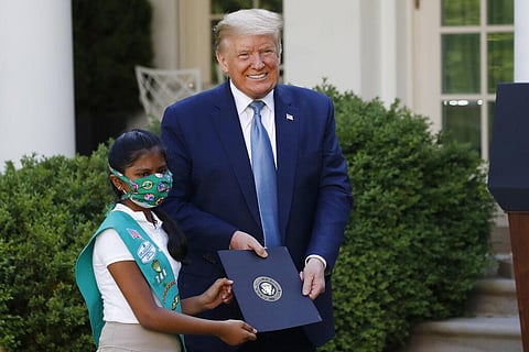 President Donald Trump poses for a photo with Girl Scout Troop 744 member Sravya Annappareddy during a presidential recognition ceremony in the Rose Garden of the White House. (Photo | AP)