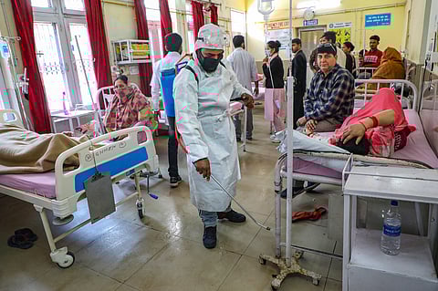 A worker sprays disinfectants inside a hospital as a measure to prevent the spread of coronavirus COVID-19 pandemic in Jammu. (File Photo | PTI)