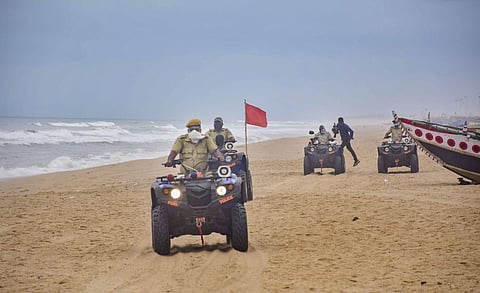Marine police personnel patrol Puri beach to prevent tourists and fishermen from venturing into the sea due to Cyclone Amphan. (Photo | PTI)
