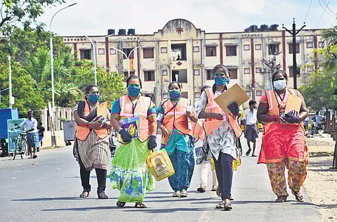A group of Corporation workers walking to the next block for door-to-door survey exercise in Kannagi Nagar | ashwin prasath