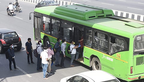 Office workers board DTC buses at Akshardham as the Delhi Government resumed bus services within the city on Tuesday. (Photo| Parveen Negi, EPS)