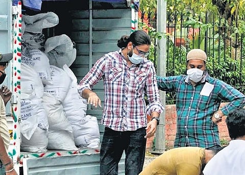 Volunteers of Hamdard National Foundation deliver ration to the underpriviledged; (left) Arushi Nishank of Sparsh Ganga Abhiyan distributing face masks at the Armed Force Clinic