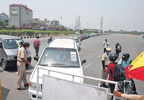 Haryana Police personnel inspect passes and identity cards of motorists, both two and four wheelers, at Delhi-Gurugram border on Tuesday | Shekhar Yadav