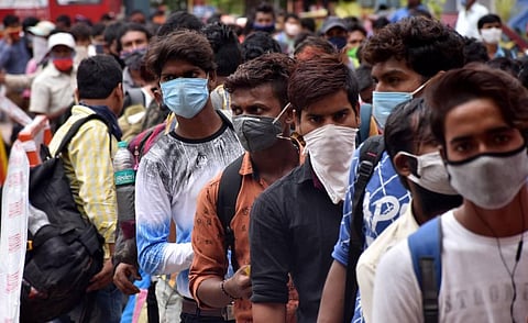 Migrants from Bihar wait in a long queue to board the special train to their hometown at Coimbatore Railway Station on Monday. (Photo | U Rakesh Kumar)