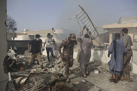 Rescue work is in progress at the site of a plane crash in Karachi, Pakistan. (Photo | AP)