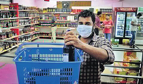 A mask-clad man buys alcohol from a Bevco outlet in Kochi before the lockdown. (Photo | A Sanesh/EPS)