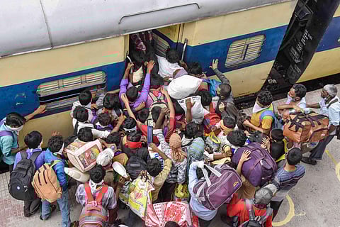 Migrants board a local train at Danapur railway station to reach their destination during the ongoing COVID-19 nationwide lockdown in Patna Saturday May 23 2020. (Photo | PTI)