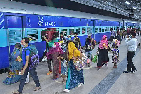 Migrants from West Bengal walk to board a train at Mathura junction during the ongoing COVID-19 nationwide lockdown in Mathura. (File Photo | PTI)