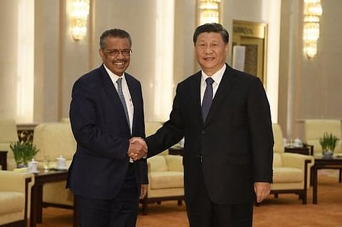 WHO Director General Tedros Adhanom Ghebreyesus with President Xi Jinping. (Photo | AFP)