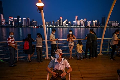 People wearing facemasks are seen on a tourist ship that sail in Yangtze River in Wuhan. (Photo | AFP)