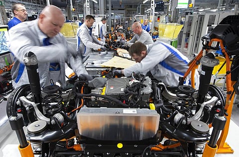 Workers complete an electric car ID.3 body at the assembly line during a press tour at the plant of the German manufacturer Volkswagen AG (VW) in Zwickau, Germany. (File photo | AP)