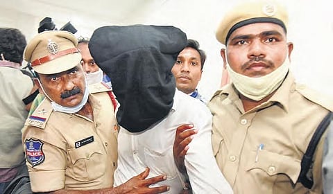 Police taking the accused, Sanjay Kumar Yadav, a native of Bihar, to be presented before the media in Warangal on Monday