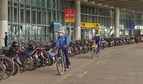 Workers ride bicycles outside the NSCBI Airport during ongoing COVID-19 lockdown in Kolkata Sunday May 24 2020. (Photo | PTI)