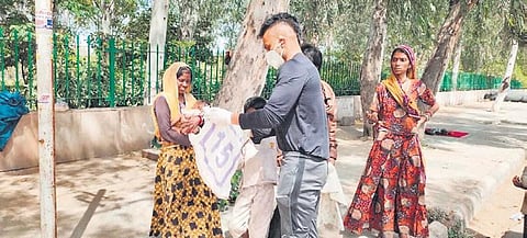 National NGO’s Amandeep Singh distributing food and essentials among the poor