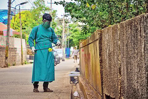 A sanitation worker sprays disinfectant near a private hospital. (Photo | Ashishkrishna HP, EPS)