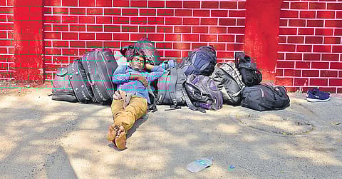 A migrant worker taking rest while waiting for transportation to reach Chennai Central on Tuesday | DEBADATTA MALLICK