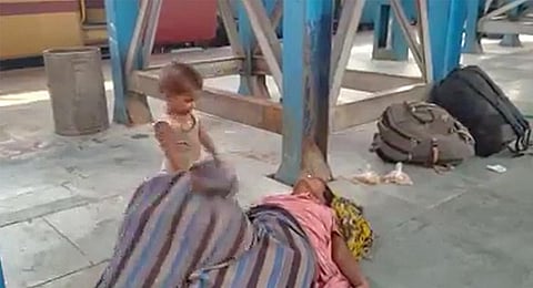 The toddler is seen pulling the shroud covering his mother. ( Videograb)