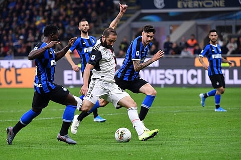 Argentinian forward Gonzalo Higuain (C) shoots to score during the Italian Serie A football match Inter vs Juventus. (Photo | AFP)