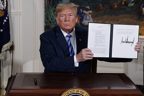 US President Donald Trump shows a signed Presidential Memorandum after delivering a statement on the Iran nuclear deal from the Diplomatic Reception Room of the White House (File Photo | AP)