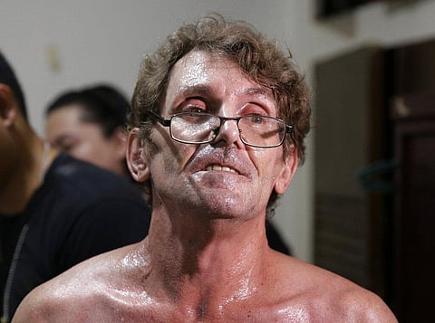 Suspected child webcam cybersex operator, American David Timothy Deakin, from Peoria, Ill., waits following his arrest as investigators gather evidence during a raid at his home in Mabalacat, northern Philippines, April 20, 2017. (Photo | AP)