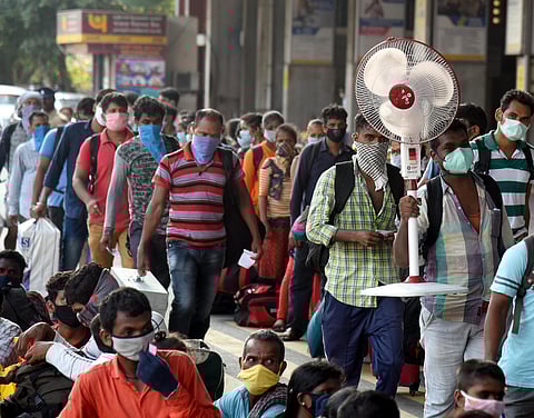 Migrants wait to board the special train to Odisha at Central railway station in Chennai on Wednesday. (Photo | Martin Louis/EPS)