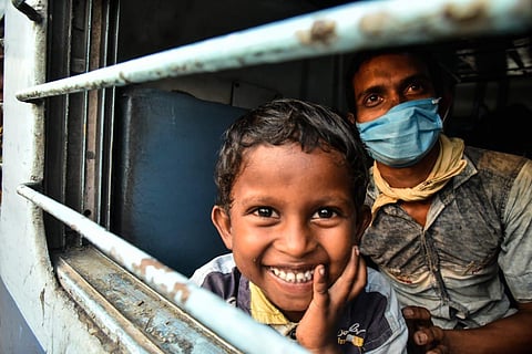 A child smiles as he sits in a Shramik train at Nampally railway station. (Photo | Vinay Madapu, EPS)