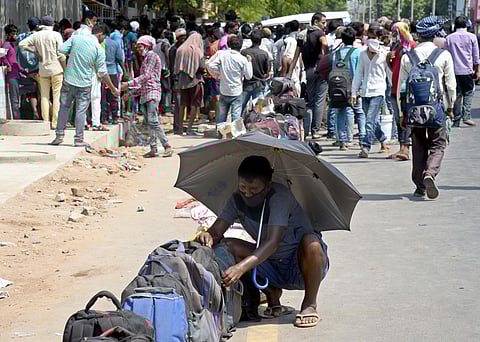 Migrant workers from Bihar gathered near Jawaharlal Nehru stadium demanding transport arrangements to go back to their native places. (Photo | Martin Louis/EPS)
