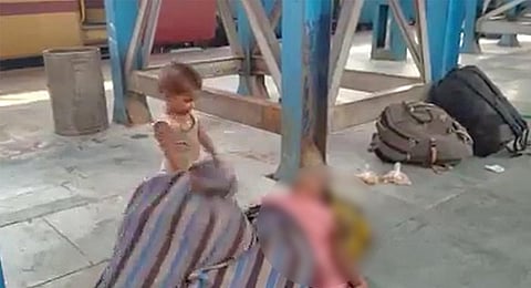 The toddler is seen pulling the shroud covering his mother. ( Videograb)