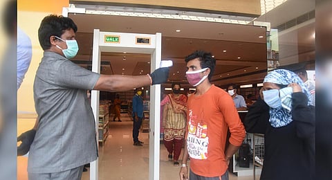 A customer at a garment showroom in Vijayawada being screened. (Photo | P Ravindra Babu, EPS)