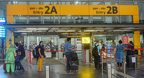 Flight passengers wait in a queue at the NSCBI Airport to catch a flight for Guwahati amid ongoing COVID-19 lockdown in Kolkata Thursday May 28 2020. (Photo | PTI)
