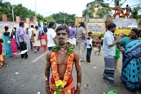 A Hindu devotee with his body pierced with skewers and walk through a road as he takes part in a religious procession during Aadi festival at elephant gate road, in Chennai. (Photo | EPS, R.Satish Babu)