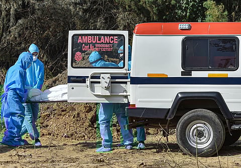 Medics and family members arrive to perform burial of a person who died of COVID-19. (Photo| PTI)