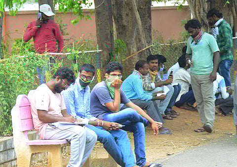 Migrant labor waiting to go back to their home places at Sub Collector office in Vijayawada on Saturday. (Photo | EPS)