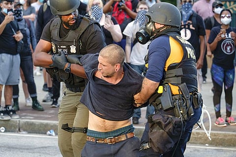 Police make arrests outside Centennial Olympic Park as protests continued for a second day over the death of George Floyd, Saturday, May 30, 2020 in Atlanta. (Photo | AP)