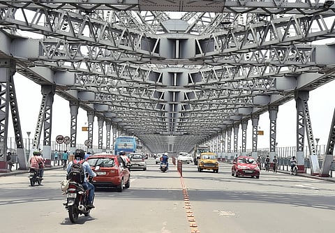 Vehicles ply on Howrah bridge after authorities eased restrictions during the 4th phase of nationwide COVID-19 lockdown in Kolkata Saturday May 30 2020. (Photo | PTI)
