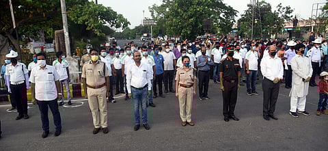 Political leaders along with security personnel and civilians singing 'Bande Utkal Janani' paying respect towards covid warriors called by Chief Minister Naveen Patnaik near AG square in Bhubaneswar on Saturday. (Photo | EPS)