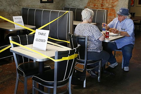 Oklahoma City, as restaurants are allowed to open for in person dining. Tables are taped off to promote social distancing. (Photo | AP)