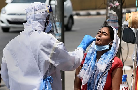 Health workers collect swab samples at a mobile COVID-19 testing van. (Photo | Parveen Negi, EPS)