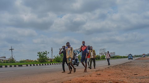 Migrant labourers on the way to their home town Jharkhand seen near NH-16 in Bhubaneswar on Monday.