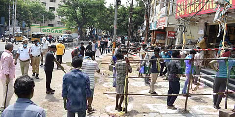 People line up to buy liquor at Yousfguda in Hyderabad as liquor shops opened in Telangana on Wednesday. (Photo| S Senbagapandiyan, EPS)