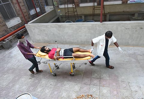 King George Hospital staff carrying one of the victims of Visakhapatnam gas tragedy (Photo | G Satyanarayana, EPS)