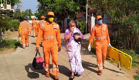 NDRF personnel evacuate an elderly woman after a major chemical gas leakage at LG Polymers industry in RR Venkatapuram village, Visakhapatnam. (Photo | PTI)