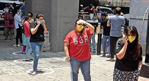 Women maintain social distance while standing in queue to buy booze at a wine shop at Jubilee Hills.