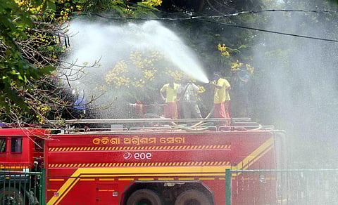 Fire Service personnel spray disinfectants in Bhubaneswar amid COVID-19 pandemic. (Photo | Irfana)
