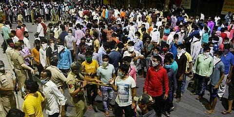 Migrant labourers, who stuck in the city during a government-imposed nationwide lockdown, protest to go back to their native place in Surat. (Photo| ANI)